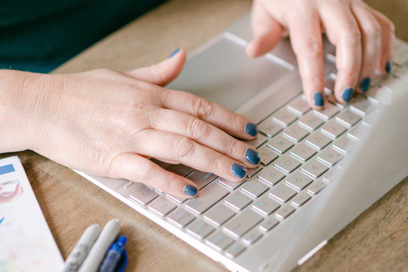 Heather typing away on a laptop