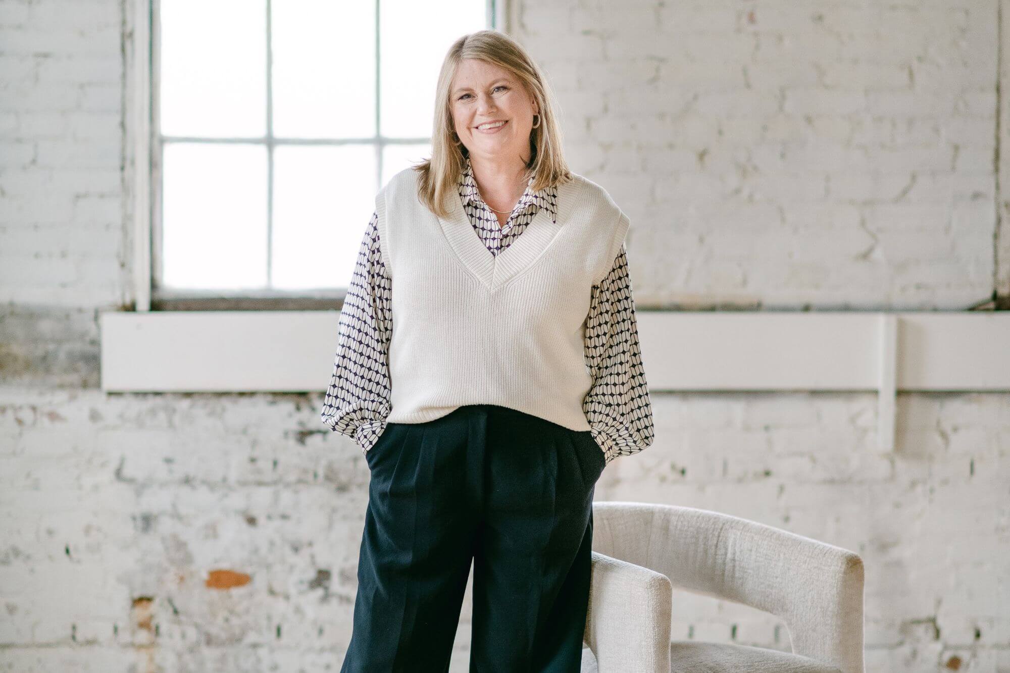 Heather standing and smiling